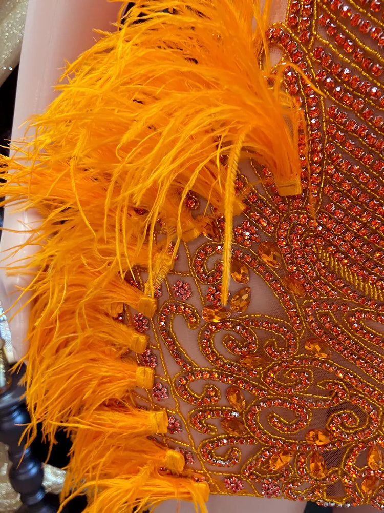 A vibrant Orange Feather Halter Rhinestone Applique Birthday Dress with a halter neckline, feather accents, and sparkling rhinestone applique, ideal for special occasions like birthdays and parties.