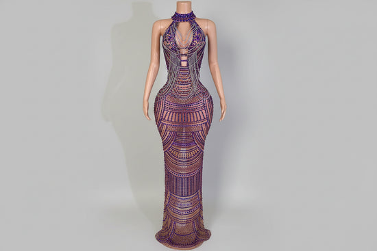 Purple beaded evening gown on a mannequin against a neutral background