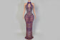 Purple beaded evening gown on a mannequin against a neutral background