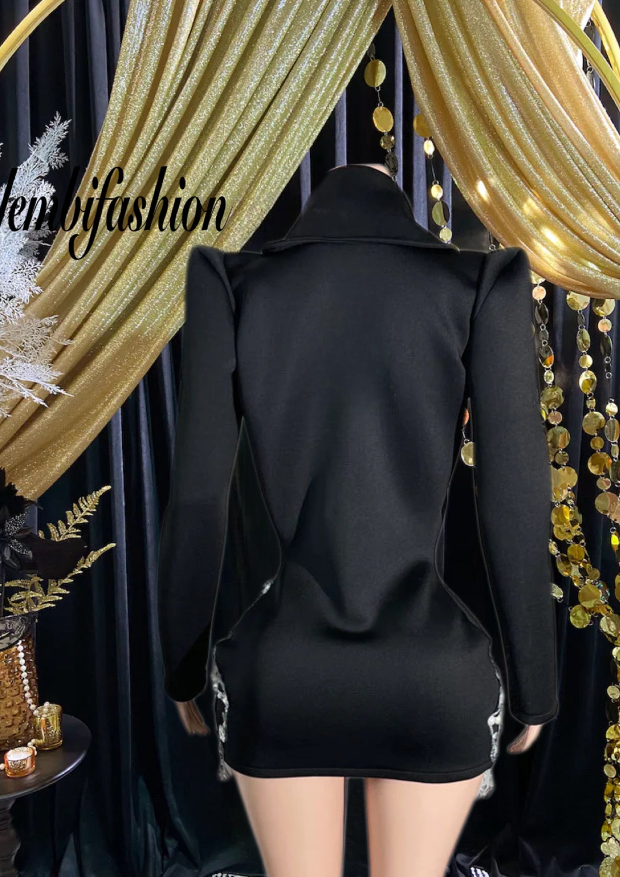 Black pearl mini dress featuring intricate pearl details and a sleek, sophisticated design.