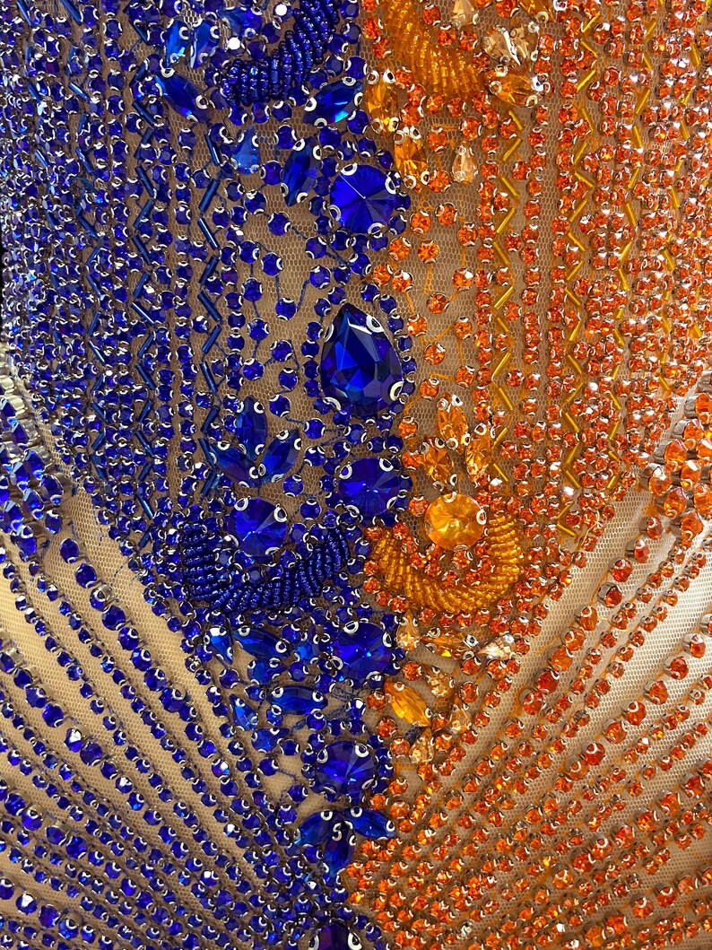 Elegant diamante gown featuring orange and blue rhinestone details