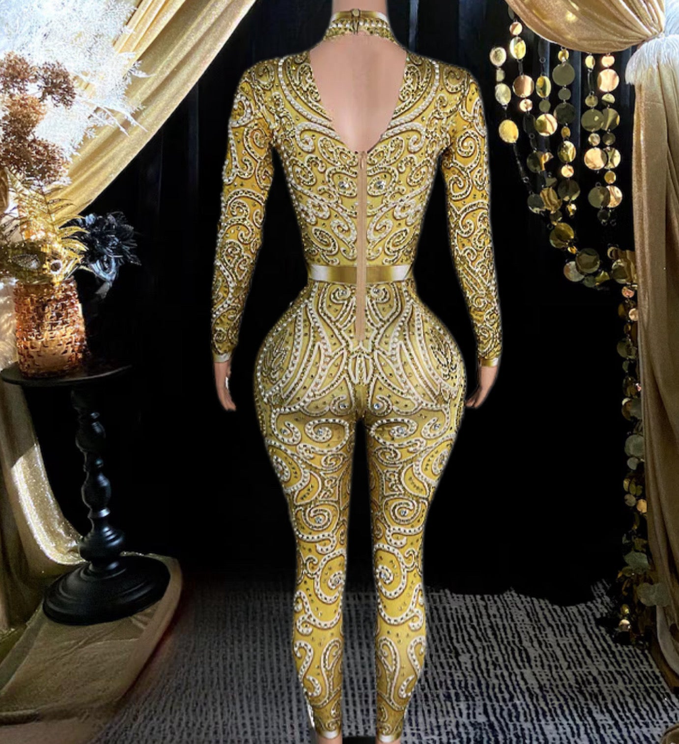 A fashionable gold rhinestone bodysuit with sparkling details, tailored for a flattering, stylish fit