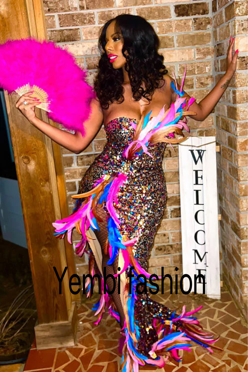 “Elegant woman wearing a black feather evening dress, accessorized with a silver clutch and matching heels, perfect for a glamorous night out.”