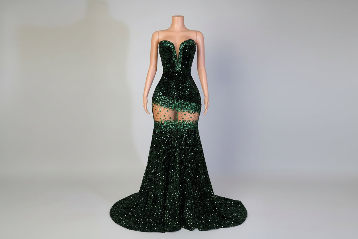 Mannequin wearing a green sequin dress in an elegant room with a plant and chair.