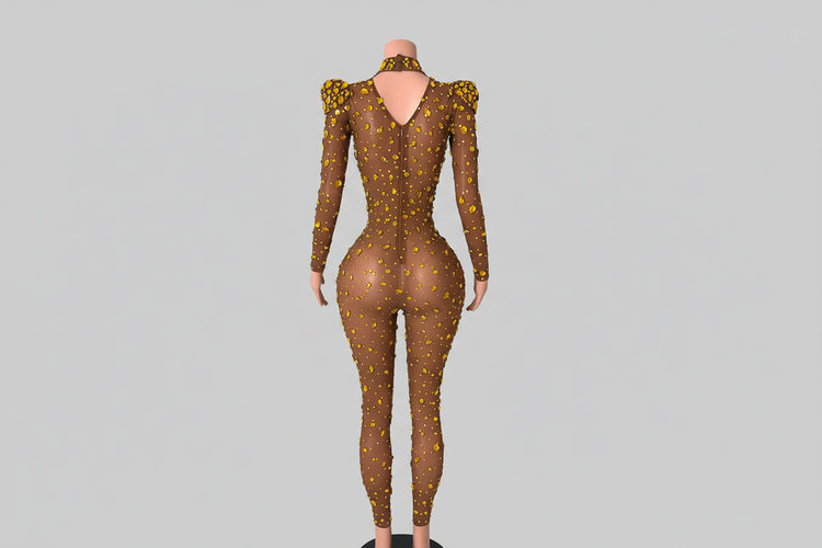Mannequin wearing a sheer brown outfit with yellow patterns in a decorative room.