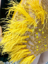 A vibrant yellow mini dress adorned with feathers and rhinestones, perfect for glamorous events and parties.