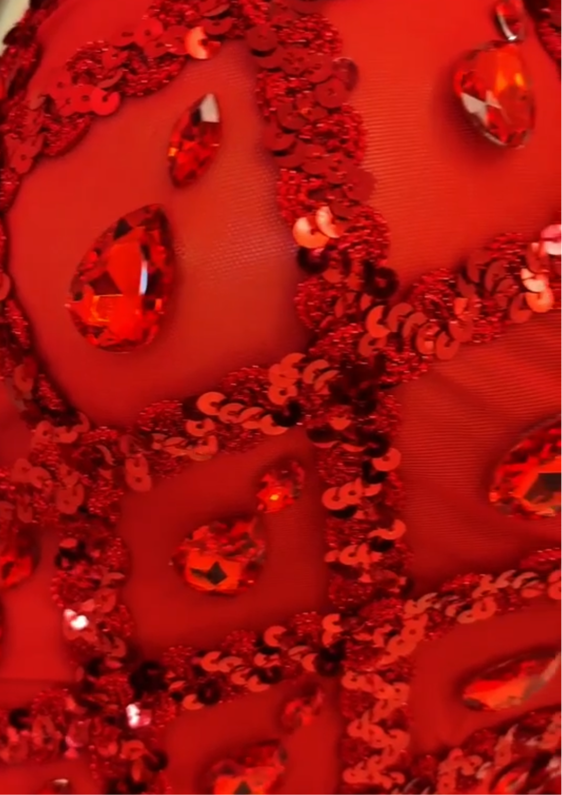 Red sparkly sequins bodysuit with intricate embellishments, perfect for cocktail events or special occasions.