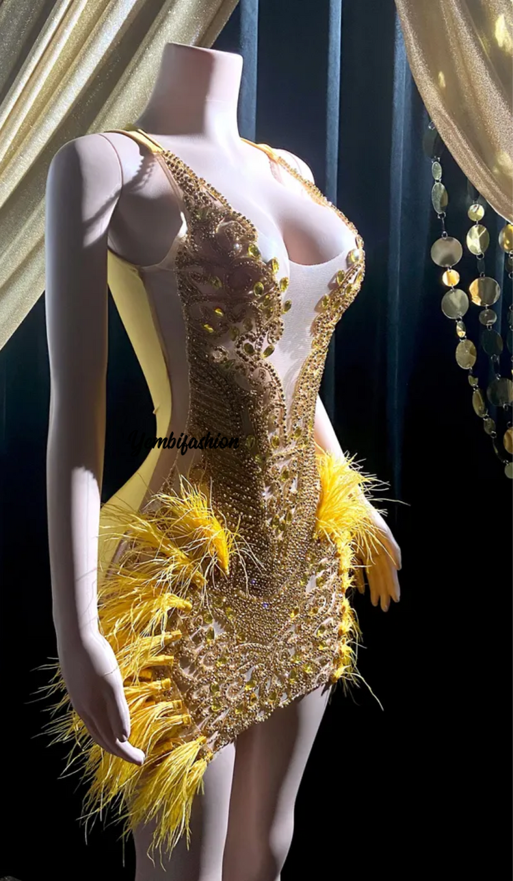 A vibrant yellow mini dress adorned with feathers and rhinestones, perfect for glamorous events and parties.