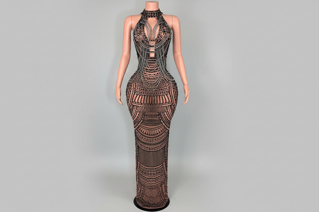 Mannequin wearing a detailed evening gown in a room with decorative elements.