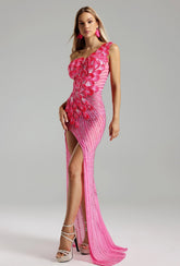 Woman wearing a Prisca rhinestone pink formal evening dress at a formal event, highlighting the rhinestone details and elegant silhouette.