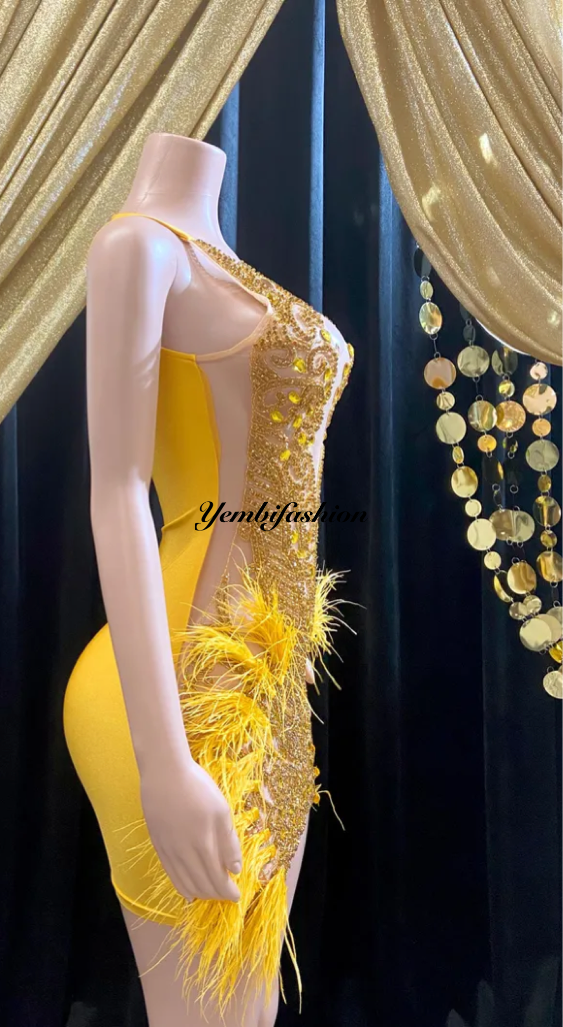 A vibrant yellow mini dress adorned with feathers and rhinestones, perfect for glamorous events and parties.
