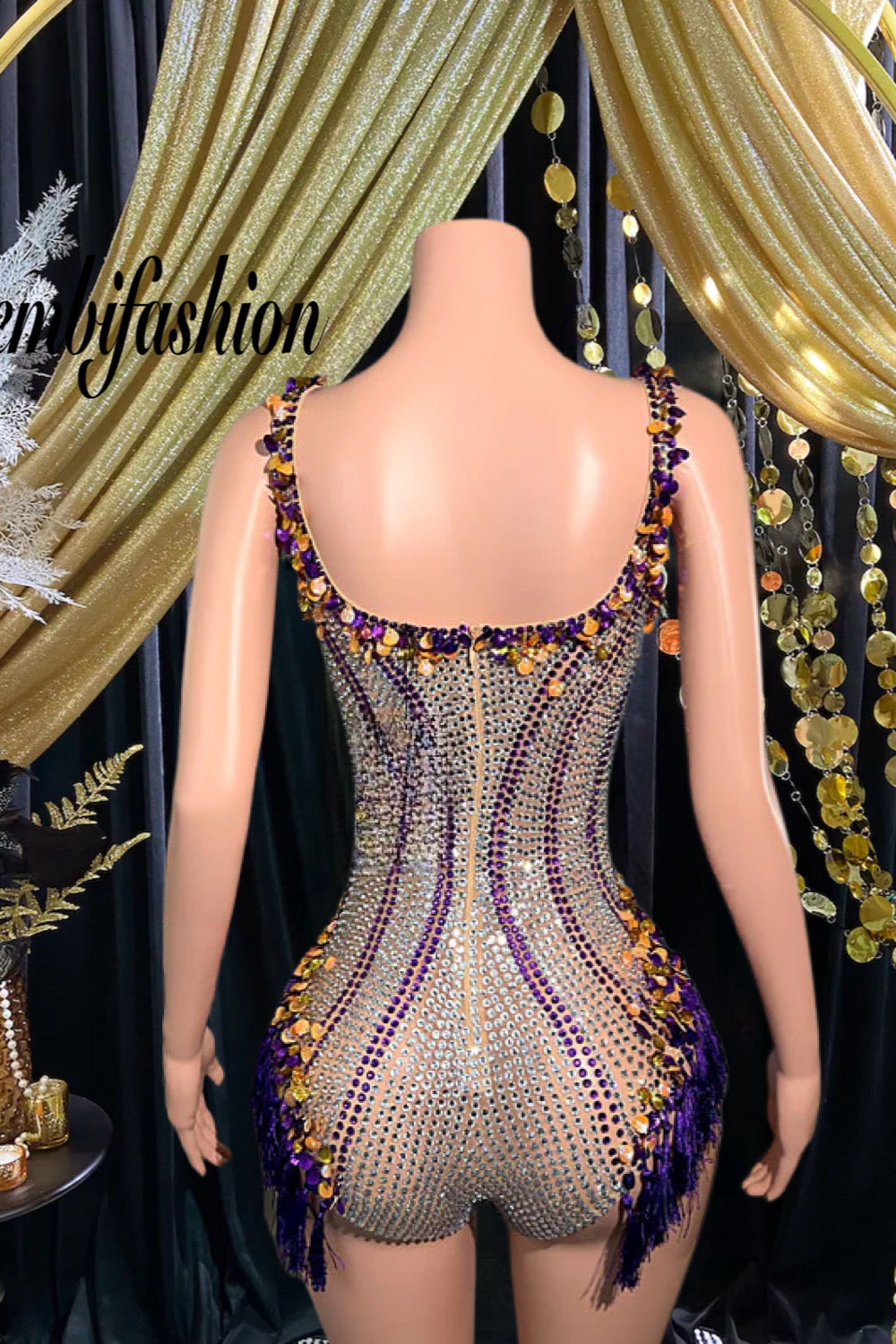 Close-up of a glamorous rhinestone tassel bodysuit with intricate detailing and flowing tassels, perfect for a stylish night out.