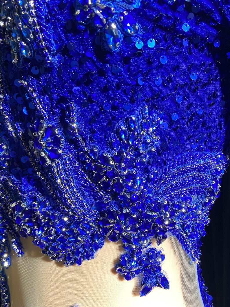 Royal blue evening dress with intricate rhinestone detailing and sparkling crystal embellishments.

Let me know if you'd like any adjustments!