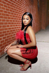 A red mini diamante dress with feather details, perfect for a glamorous evening or party