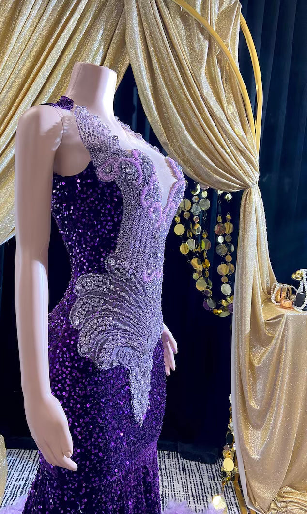 A glamorous embellished sequin dress with rhinestones, featuring a sparkling design perfect for evening wear and formal events