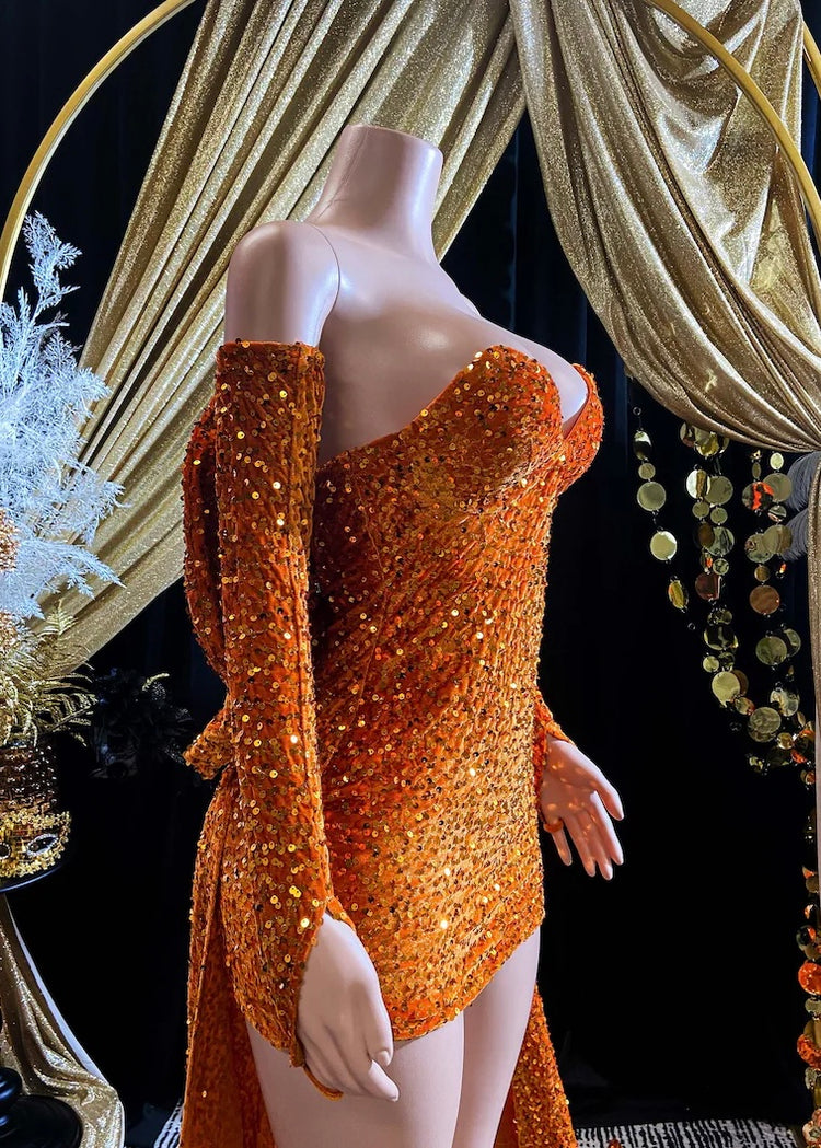 A vibrant orange Eve Sequin Evening Dress styled as a ball gown, with intricate crystal embellishments and shimmering sequins, perfect for formal occasions and elegant events.