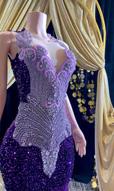 A glamorous embellished sequin dress with rhinestones, featuring a sparkling design perfect for evening wear and formal events