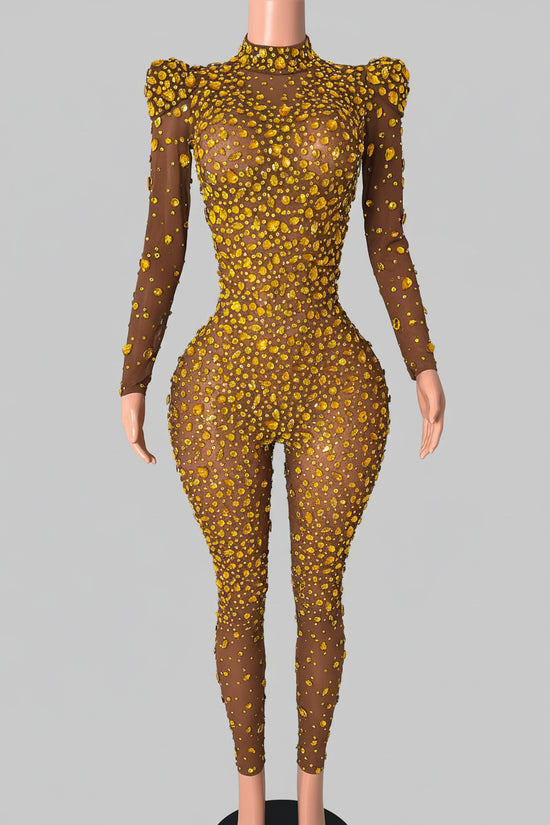 Person wearing a sheer brown dress with yellow floral patterns in a room.