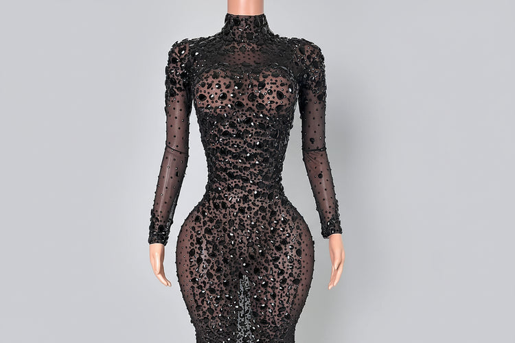 Black sequin dress on a mannequin against a white background