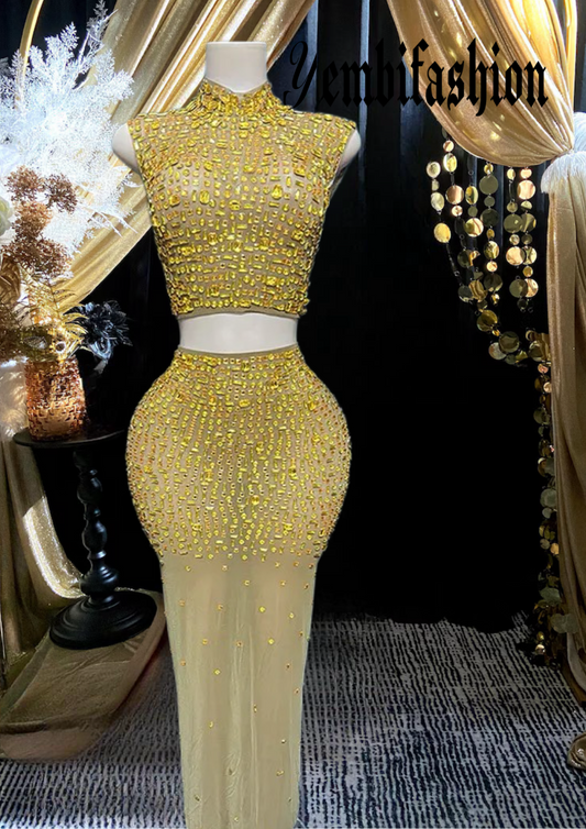 A luxurious gold diamante set dress with intricate diamante embellishments, featuring a figure-hugging silhouette, perfect for special occasions and formal events.

