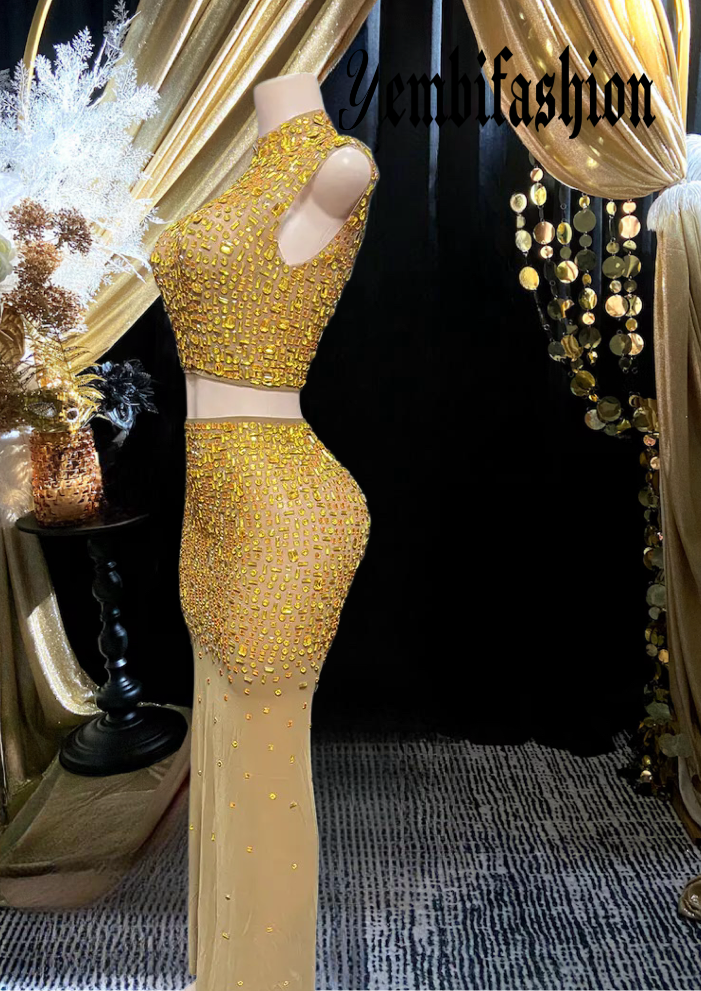 A luxurious gold diamante set dress with intricate diamante embellishments, featuring a figure-hugging silhouette, perfect for special occasions and formal events.

