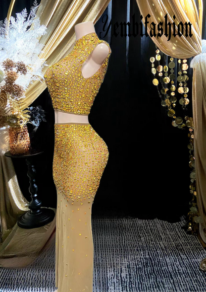 A luxurious gold diamante set dress with intricate diamante embellishments, featuring a figure-hugging silhouette, perfect for special occasions and formal events.

