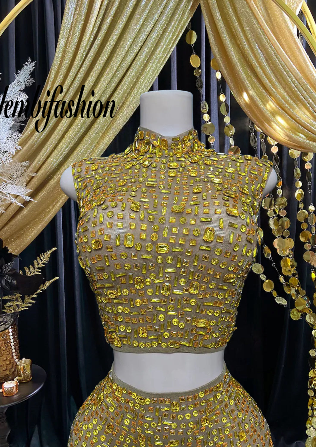 A luxurious gold diamante set dress with intricate diamante embellishments, featuring a figure-hugging silhouette, perfect for special occasions and formal events.

