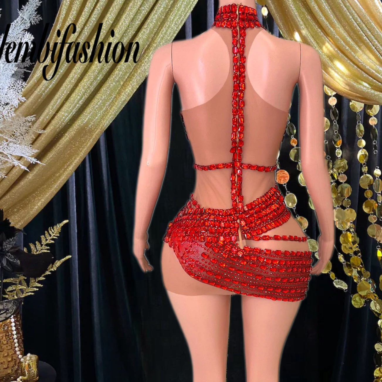 A vibrant red mini dress with crystal and rhinestone detailing, designed for elegant and bold occasions.