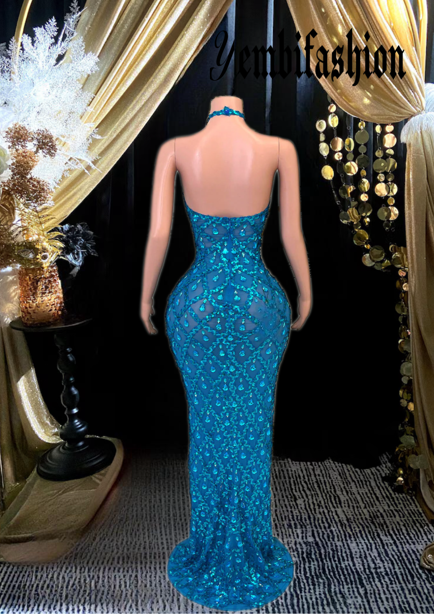 A long sleeveless midi dress adorned with rhinestones, showcasing an elegant and modern design.