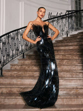 A chic black feather dress perfect for homecoming or as a stylish prom dress, featuring elegant feather details and a sleek silhouette