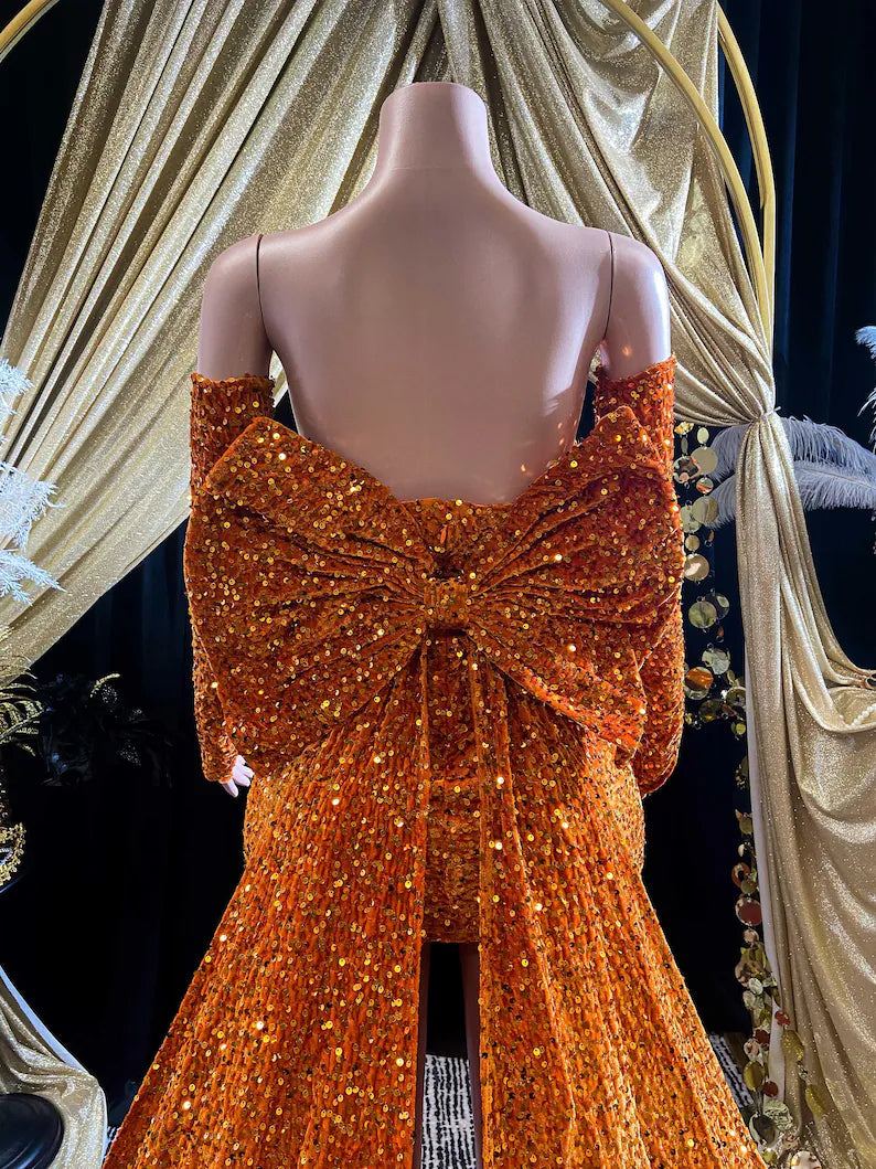 A vibrant orange Eve Sequin Evening Dress styled as a ball gown, with intricate crystal embellishments and shimmering sequins, perfect for formal occasions and elegant events.
