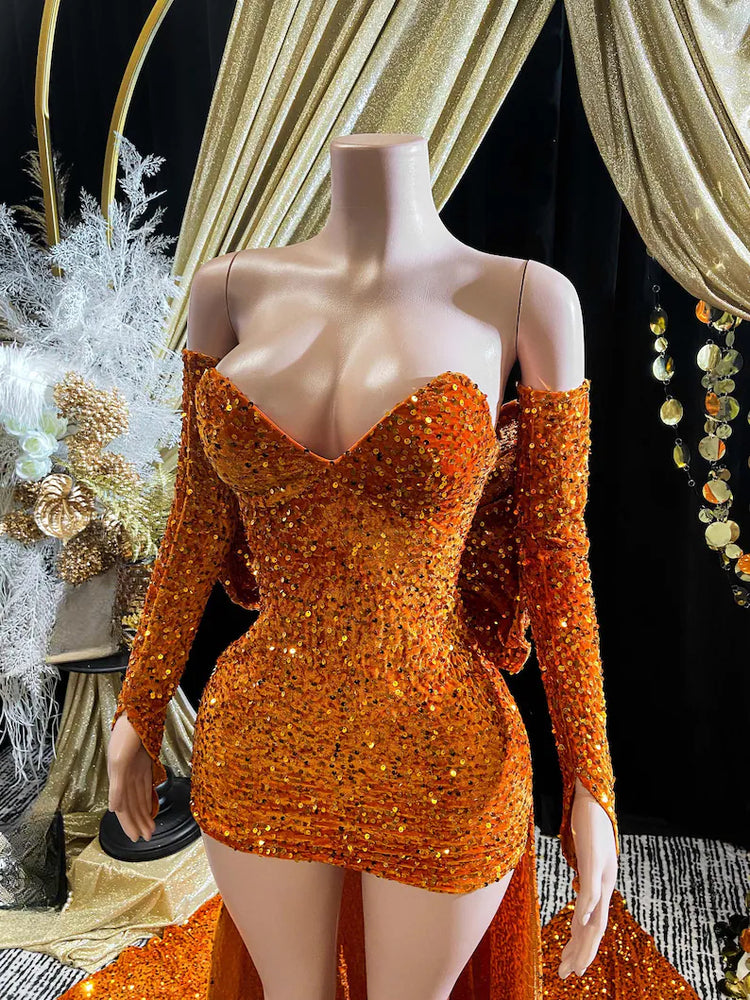 A vibrant orange Eve Sequin Evening Dress styled as a ball gown, with intricate crystal embellishments and shimmering sequins, perfect for formal occasions and elegant events.