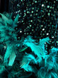 Dark green feather-embellished mini dress with rhinestone details, perfect for a birthday celebration or special event.