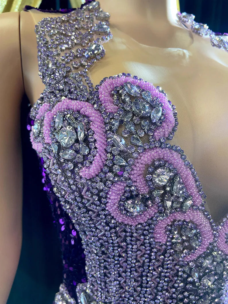 A glamorous embellished sequin dress with rhinestones, featuring a sparkling design perfect for evening wear and formal events