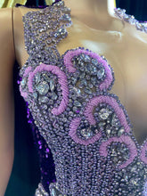 A glamorous embellished sequin dress with rhinestones, featuring a sparkling design perfect for evening wear and formal events