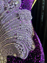 A glamorous embellished sequin dress with rhinestones, featuring a sparkling design perfect for evening wear and formal events