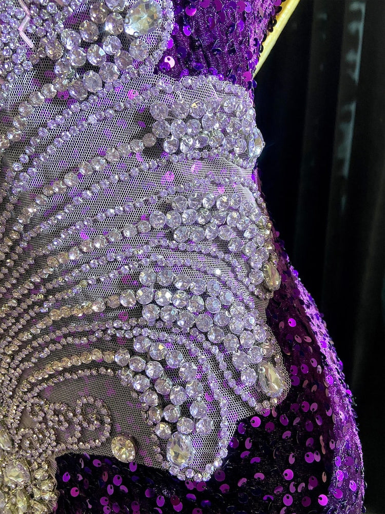A glamorous embellished sequin dress with rhinestones, featuring a sparkling design perfect for evening wear and formal events