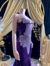 A glamorous embellished sequin dress with rhinestones, featuring a sparkling design perfect for evening wear and formal events