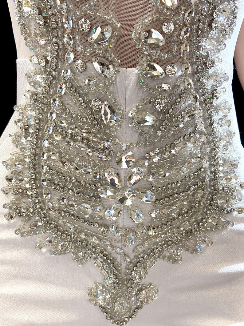 Eve White Bodysuit featuring glitter details and rhinestone embellishments for a glamorous look