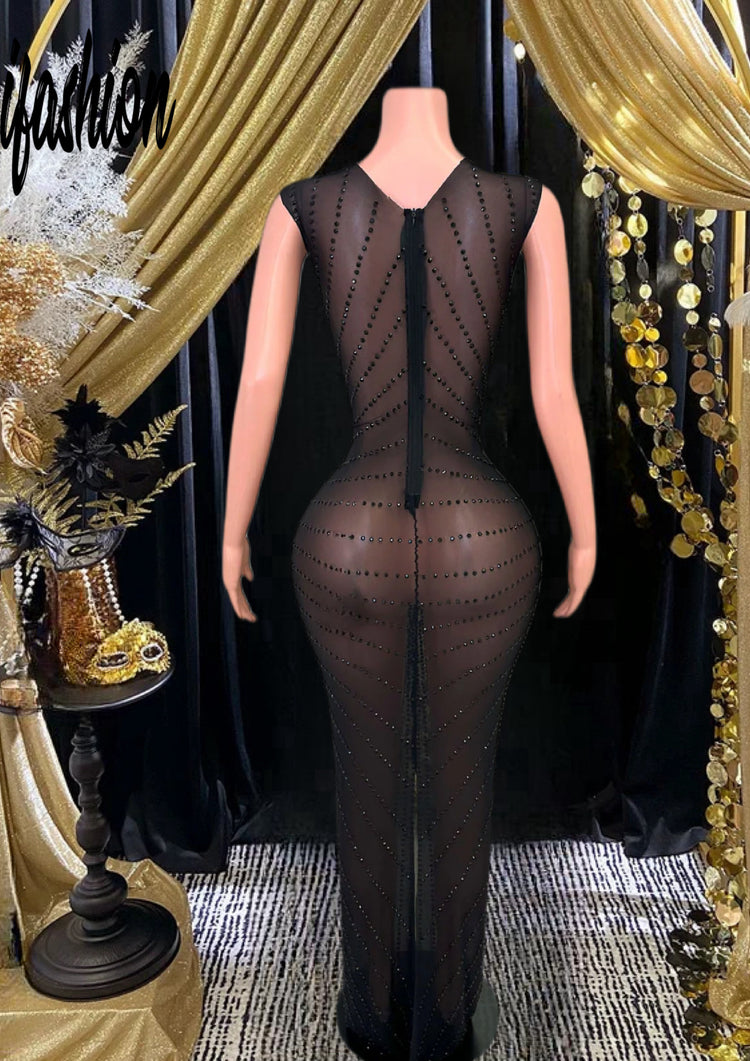 A glamorous Queen Maxi Dress featuring diamond-inspired accents and rhinestone embellishments, showcasing an elegant and flowing maxi silhouette