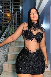 A sleek black bodycom dress with mesh detailing, highlighting a form-fitting silhouette for an elegant and sophisticated look.