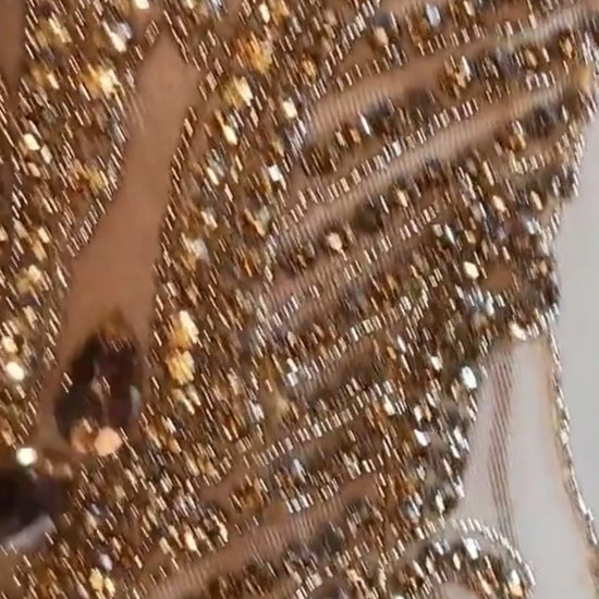 Front view of a gold rhinestone A-line mini dress with sparkling rhinestones and an elegant fit.