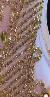 A vibrant yellow mini dress adorned with feathers and rhinestones, perfect for glamorous events and parties.