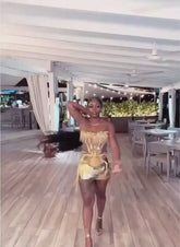 Model wearing a glamorous Rhinestone Dress Set with tassel dress details, perfect for special occasions."